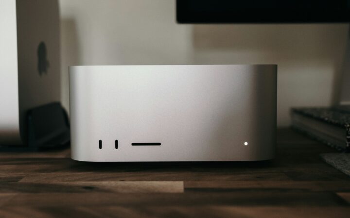 A silver Mac Studio on a wooden desk, photographed by Joey Banks in 2022