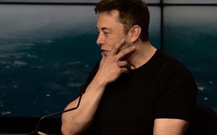 Elon Musk in profile with his hand resting against his cheek, photographed by Daniel Oberhaus in 2019