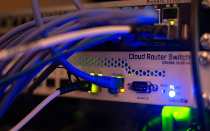 Ethernet cables connected to network switches in an equipment rack, illustrating data center networking